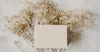 Premium greeting card styled with delicate neutral flowers